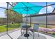 Comfortable patio with outdoor seating and shade umbrella at 1103 Cypress Pointe Blvd, Davenport, FL 33896