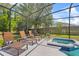 Relaxing screened-in pool area with sun loungers and inviting hot tub at 1103 Cypress Pointe Blvd, Davenport, FL 33896