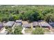 An aerial shot showing residential homes surrounded by mature trees in a quiet, established neighborhood at 118 Deacon Jones Blvd, Orlando, FL 32810
