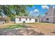 A spacious backyard features a white exterior with sliding glass doors, perfect for outdoor living at 118 Deacon Jones Blvd, Orlando, FL 32810