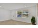 Bright bedroom with wood flooring, a large window, and fresh paint, creating a serene retreat at 118 Deacon Jones Blvd, Orlando, FL 32810