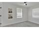 Cozy bedroom boasts a modern ceiling fan, natural light, and neutral walls at 118 Deacon Jones Blvd, Orlando, FL 32810