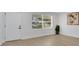 Bright bedroom with wood flooring, a large window, and freshly painted walls, creating a serene retreat at 118 Deacon Jones Blvd, Orlando, FL 32810