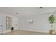 Bright and minimalist bedroom features laminate flooring, white walls, and a modern art collection at 118 Deacon Jones Blvd, Orlando, FL 32810