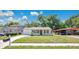 A well-maintained single-story house featuring a neat front yard and freshly painted white exterior at 118 Deacon Jones Blvd, Orlando, FL 32810