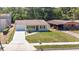 Beautifully updated single-story home with a spacious driveway, manicured lawn, and inviting front facade at 118 Deacon Jones Blvd, Orlando, FL 32810