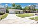 Charming single-story home featuring a well-manicured lawn, long driveway, and inviting curb appeal at 118 Deacon Jones Blvd, Orlando, FL 32810