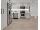 Bright kitchen with stainless appliances, sleek white cabinetry, and a functional layout for cooking and entertaining at 118 Deacon Jones Blvd, Orlando, FL 32810