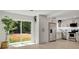 Modern kitchen featuring stainless steel appliances, sleek cabinetry, and a sliding door to the backyard at 118 Deacon Jones Blvd, Orlando, FL 32810