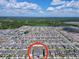 Aerial view showcasing a neighborhood with bodies of water, green spaces and many homes at 1181 Lone Palm Way, St Cloud, FL 34771