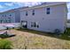 Home exterior with a spacious backyard with patio and lounge chairs at 1181 Lone Palm Way, St Cloud, FL 34771
