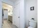 Bathroom with tiled floors, a double sink vanity, and crisp white walls providing a clean aesthetic at 1181 Lone Palm Way, St Cloud, FL 34771