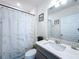 A well-lit bathroom featuring a shower, toilet, and modern gray vanity with white countertop at 1181 Lone Palm Way, St Cloud, FL 34771