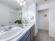 Bathroom with double sinks, granite countertop and tiled floors at 1181 Lone Palm Way, St Cloud, FL 34771