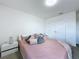 Bedroom with soft, blush-colored bedding, neutral walls, and soft lighting at 1181 Lone Palm Way, St Cloud, FL 34771