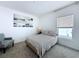 Cozy bedroom with a patterned bedspread, neutral walls, and carpet flooring at 1181 Lone Palm Way, St Cloud, FL 34771