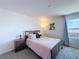 Bedroom with a warm brown bed frame and a window, offering a comfortable retreat at 1181 Lone Palm Way, St Cloud, FL 34771