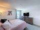 A comfortable bedroom featuring a stylish bed, framed artwork, and neutral walls at 1181 Lone Palm Way, St Cloud, FL 34771