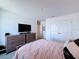A simple, yet stylish bedroom with neutral walls, closet, television, and modern decor at 1181 Lone Palm Way, St Cloud, FL 34771