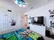Charming bedroom with a Minecraft-themed bedspread and blue cloud light fixture above the bed at 1181 Lone Palm Way, St Cloud, FL 34771