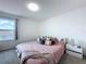 Bedroom with pink bedding and a large window, creating a relaxing atmosphere at 1181 Lone Palm Way, St Cloud, FL 34771