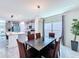 Bright dining area featuring modern light fixture, a table with six chairs and view of the kitchen at 1181 Lone Palm Way, St Cloud, FL 34771
