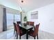 Well-lit dining area featuring tile flooring and a modern light fixture, creating a pleasant atmosphere at 1181 Lone Palm Way, St Cloud, FL 34771