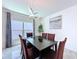 Dining room with modern light fixture, table with seating for six, and natural light at 1181 Lone Palm Way, St Cloud, FL 34771