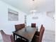Dining area with tile flooring, modern lighting, and neutral decor; the space is bright and inviting at 1181 Lone Palm Way, St Cloud, FL 34771