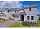Two-story home with a brick paver driveway, landscaping and a two-car garage at 1181 Lone Palm Way, St Cloud, FL 34771