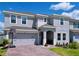 Two-story home with a brick paver driveway, landscaping and a two-car garage at 1181 Lone Palm Way, St Cloud, FL 34771