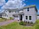 Two-story home with a brick paver driveway, landscaping and a two-car garage at 1181 Lone Palm Way, St Cloud, FL 34771