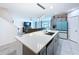 Open concept kitchen with a large island, modern appliances, and seamless flow to the living area at 1181 Lone Palm Way, St Cloud, FL 34771