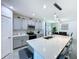 Bright kitchen with an extended island, stylish gray cabinets, and open layout to the dining area at 1181 Lone Palm Way, St Cloud, FL 34771