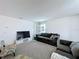 Upstairs living area with neutral carpet, plush seating, and wall-mounted TV at 1181 Lone Palm Way, St Cloud, FL 34771