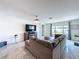 Bright living room featuring a large sectional, modern lighting, and tile flooring at 1181 Lone Palm Way, St Cloud, FL 34771