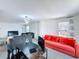 Bright living room featuring modern lighting, neutral walls, and an orange sofa, creating a cozy, inviting space at 1181 Lone Palm Way, St Cloud, FL 34771