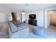Relaxing living area with plush seating, tile flooring, and entertainment center; perfect for movie nights at 1181 Lone Palm Way, St Cloud, FL 34771