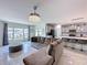 Bright living room with comfortable sofa and chairs, open to the kitchen, creating a welcoming atmosphere at 1181 Lone Palm Way, St Cloud, FL 34771