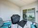 Cozy patio area with chairs, grill, and sliding glass doors at 1181 Lone Palm Way, St Cloud, FL 34771