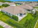 Aerial view of the backyard, showcasing the manicured lawn, patio area, and landscaped perimeter at 12313 Prairie Plantation Way, Orlando, FL 32824