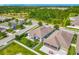 Aerial view displaying a well-kept home in a planned community with lush landscaping, and serene surroundings at 12313 Prairie Plantation Way, Orlando, FL 32824
