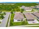 Aerial view showcases a home with well-maintained landscaping, fenced yard, and a neighborhood lake at 12313 Prairie Plantation Way, Orlando, FL 32824