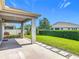 View of the well-manicured lawn and privacy hedges from the covered patio at 12313 Prairie Plantation Way, Orlando, FL 32824