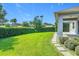 Well-manicured backyard with lush green grass and privacy hedges, offering a serene outdoor retreat at 12313 Prairie Plantation Way, Orlando, FL 32824