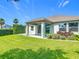 Lush backyard featuring a covered patio, green grass, and landscaping offering a private outdoor space at 12313 Prairie Plantation Way, Orlando, FL 32824