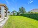 Spacious backyard with lush green grass and privacy hedges at 12313 Prairie Plantation Way, Orlando, FL 32824