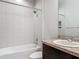 Clean bathroom with tiled walls, tub, shower, sink and granite countertop at 12313 Prairie Plantation Way, Orlando, FL 32824