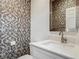 Chic powder room showcases designer wallpaper, modern vanity, and stylish fixtures for a refined look at 12313 Prairie Plantation Way, Orlando, FL 32824