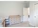 Bright bedroom features a neutral dresser, white door and trim, and soft carpet at 12313 Prairie Plantation Way, Orlando, FL 32824